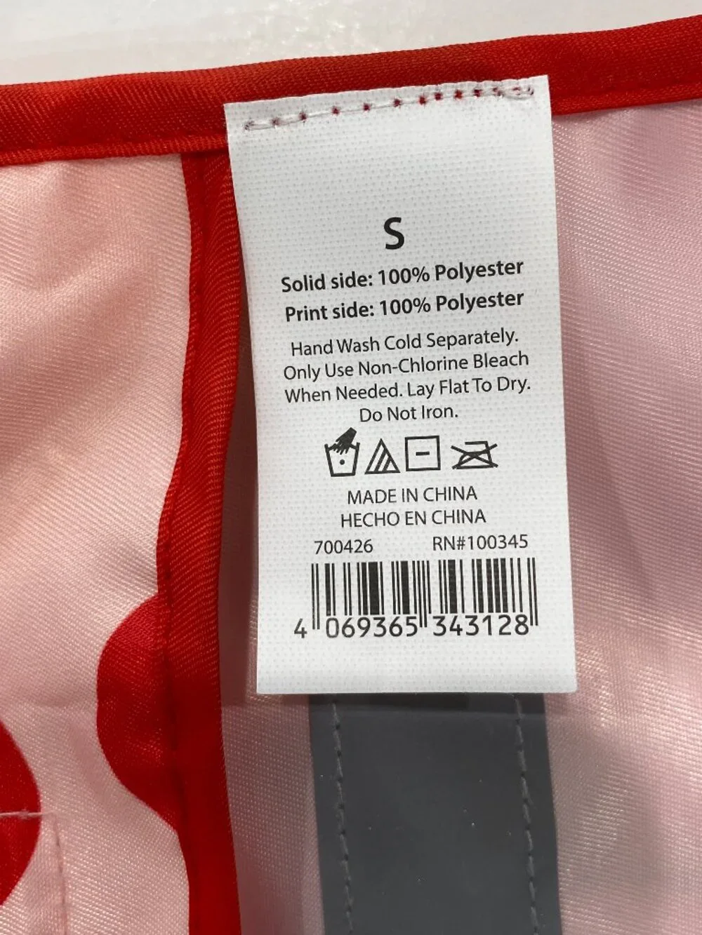 Cherry NWOT small dog raincoat with hood and reflective strip.